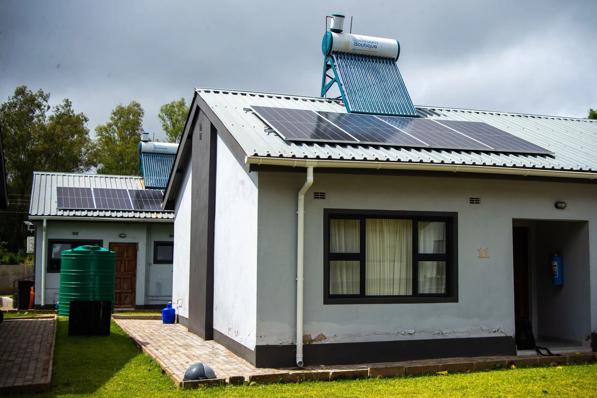 Estate home with solar panels and a solar geyser on the roof