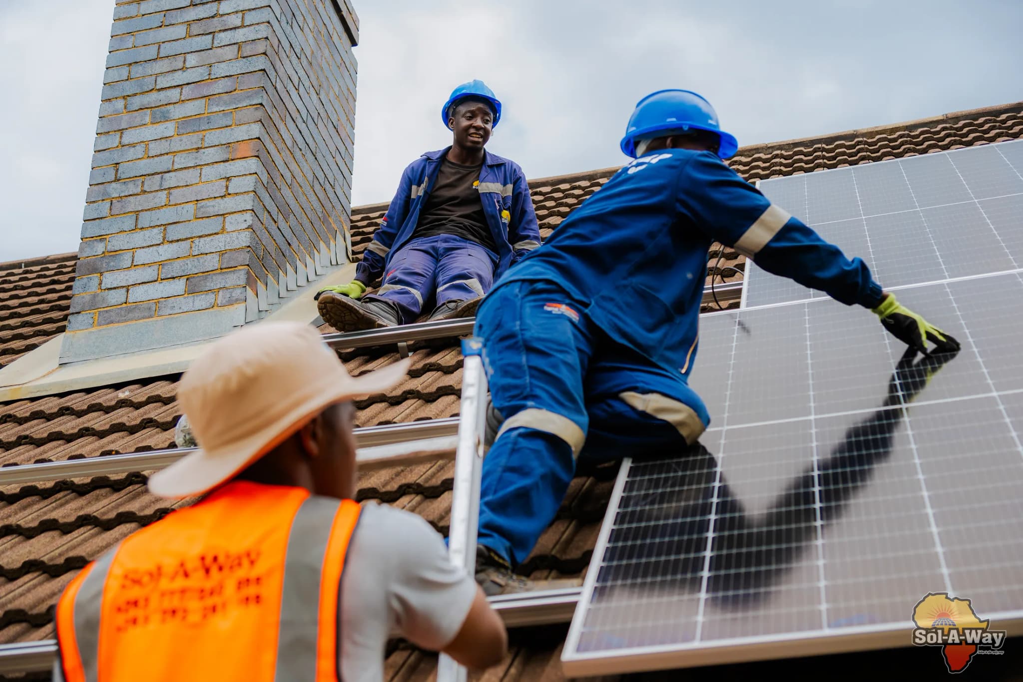 Sol-A-Way technicians fixing solar panels on a tiled roof in Bulawayo