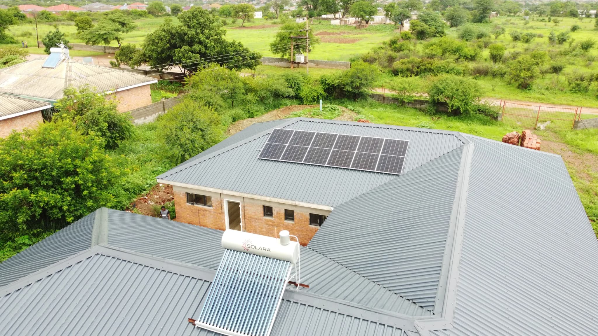 Aerial view of the Mustard Seed home with solar panels on the roof