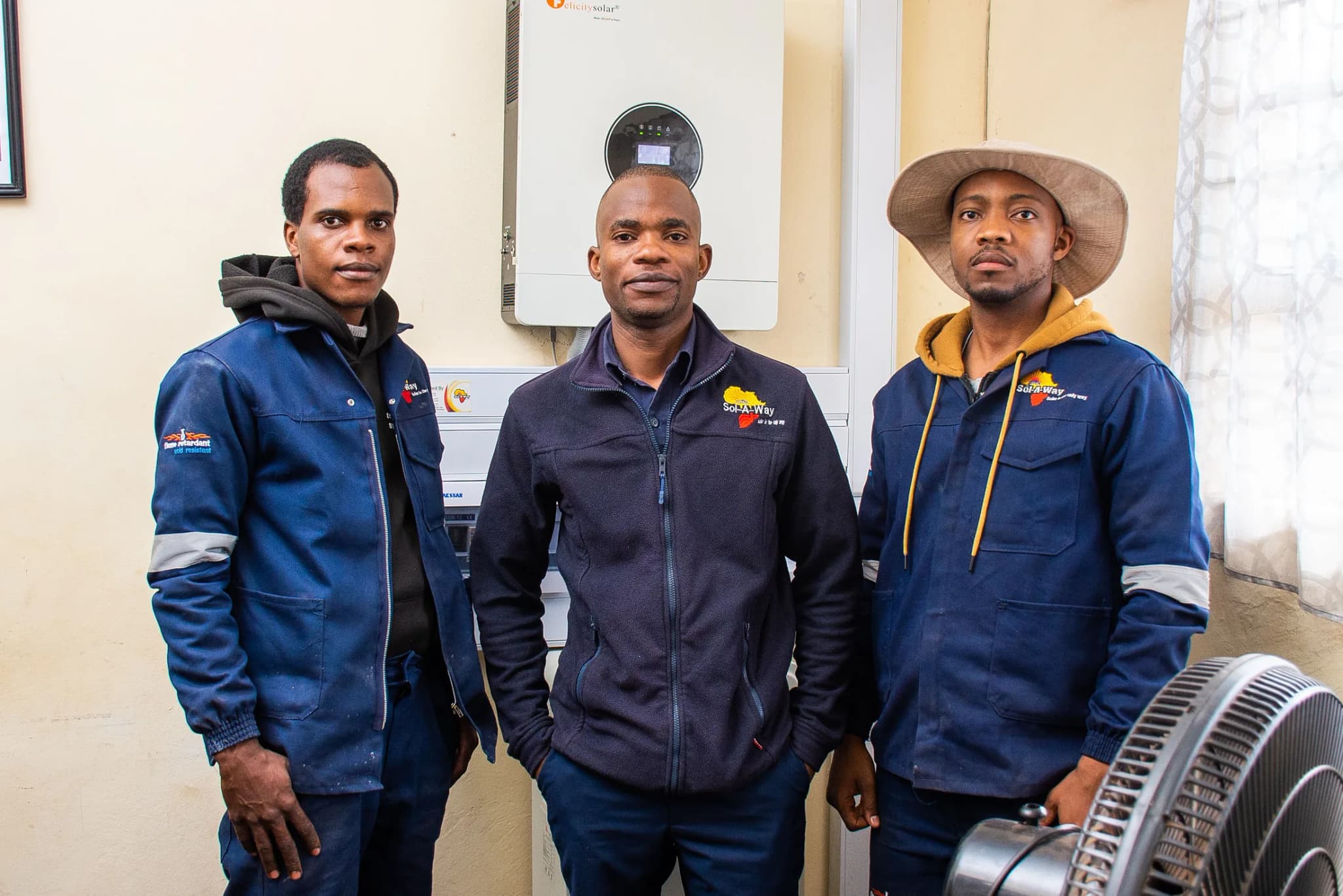 Three Sol-A-Way technicians standing beside a finished inverter install