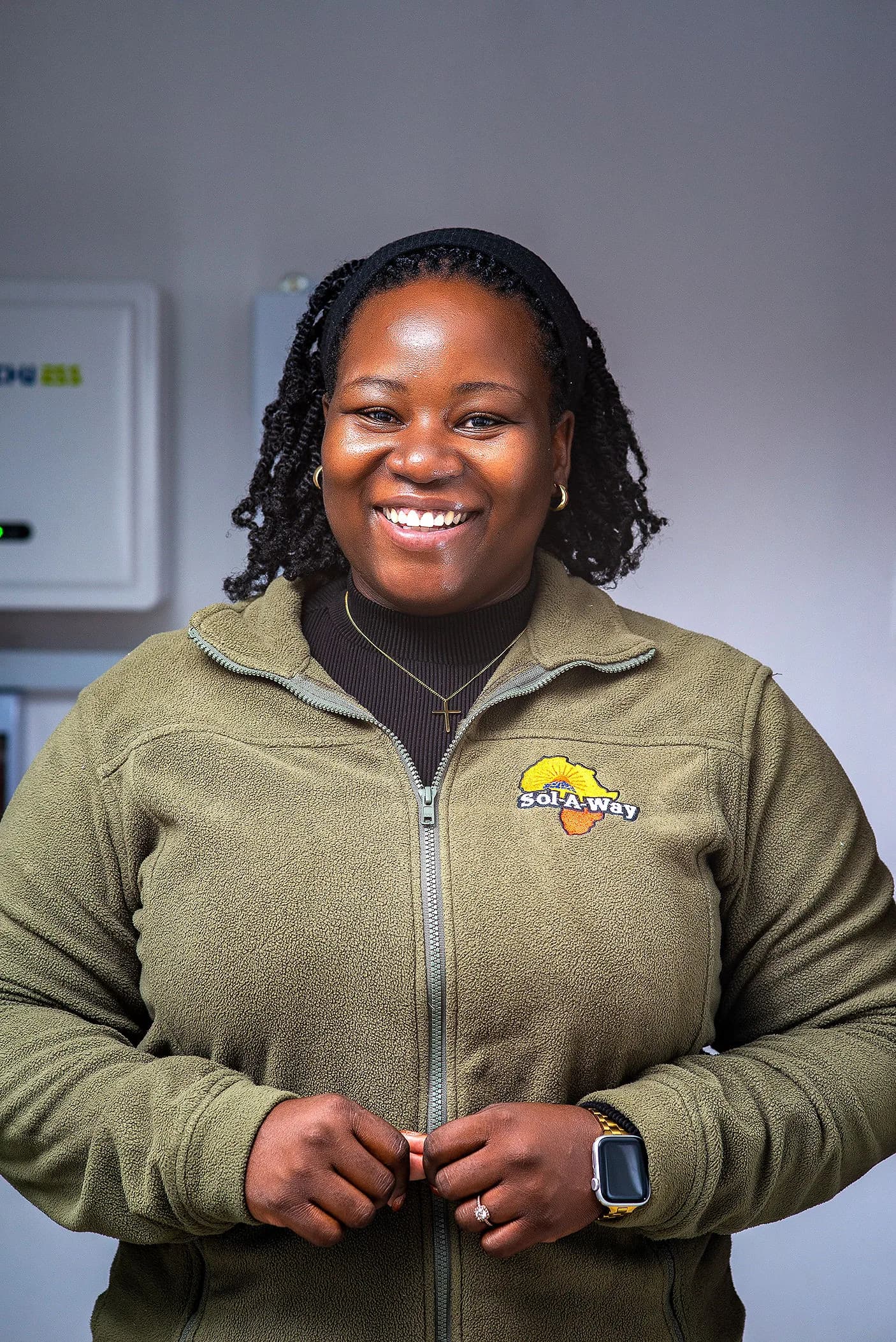Sol-A-Way team member in a branded fleece, smiling