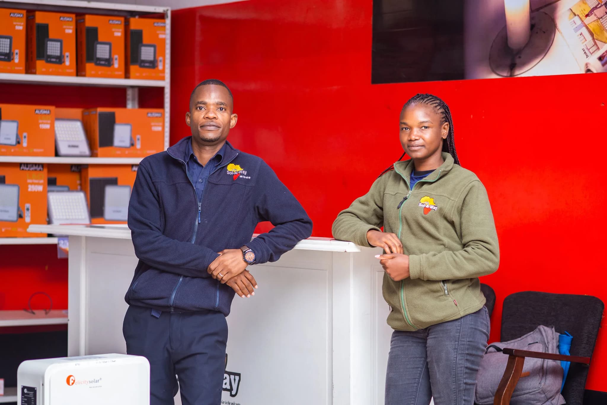 Two Sol-A-Way staff at the Bulawayo showroom counter