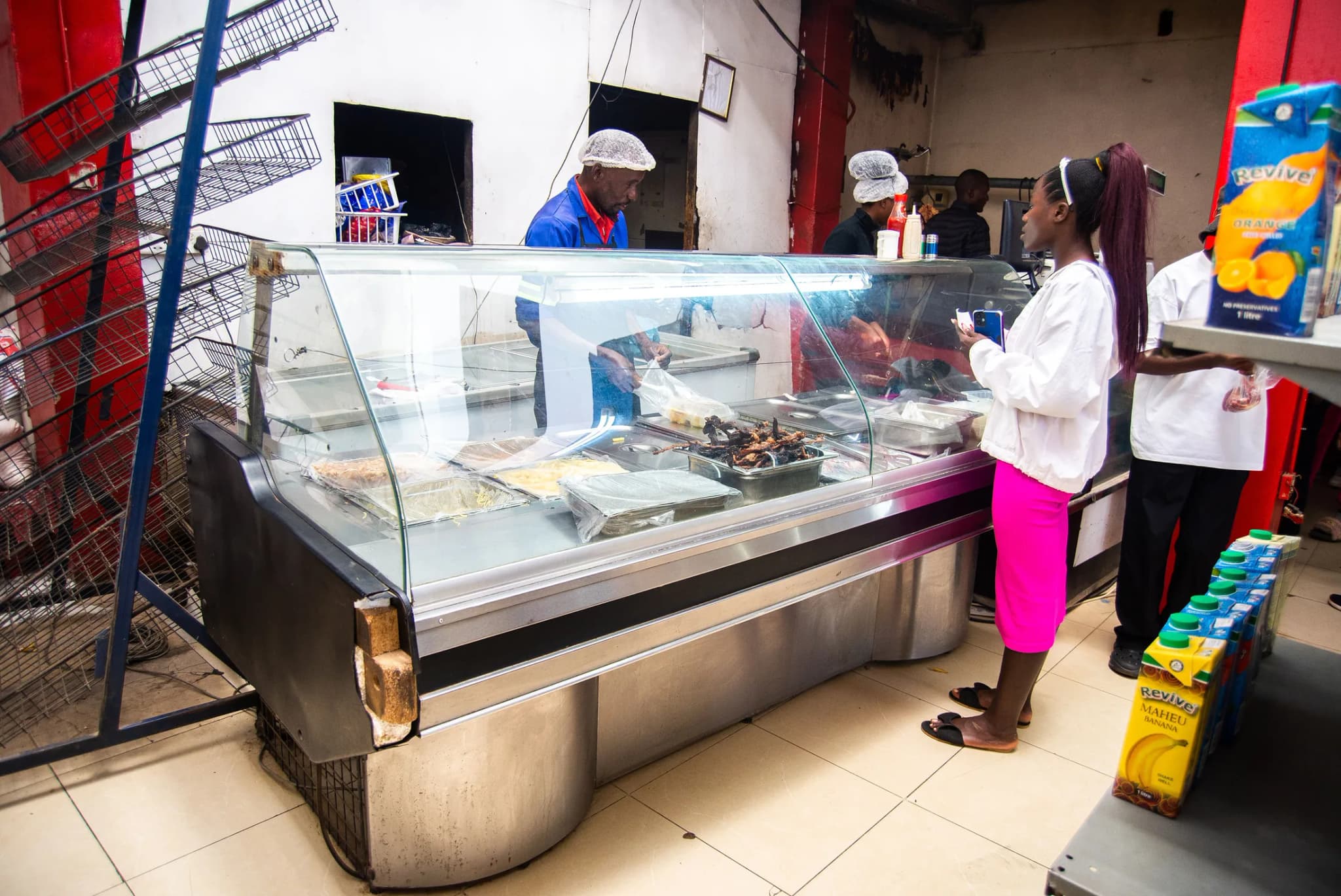 Customer at the butchery counter inside Cooland Supermarket in Maphisa