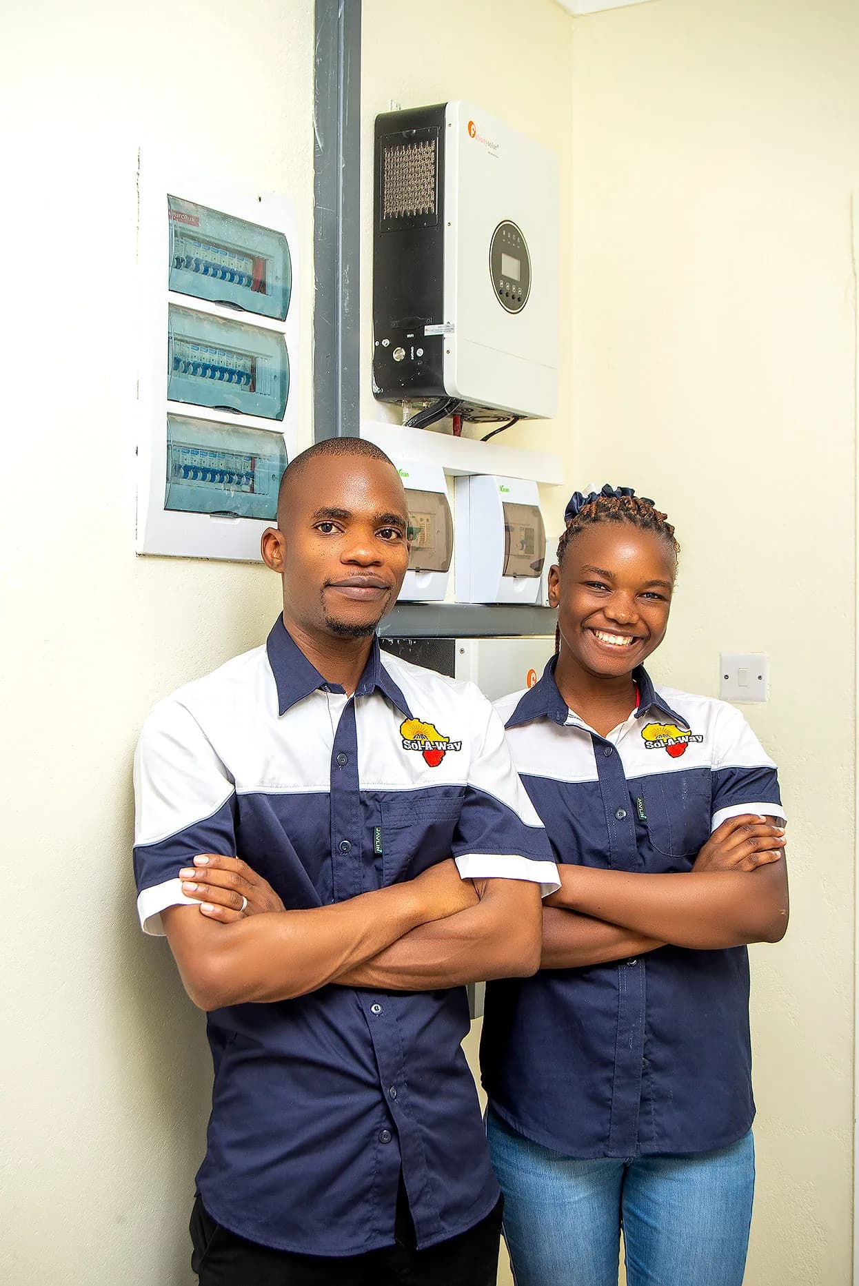 Two Sol-A-Way technicians beside the completed Mustard Seed install