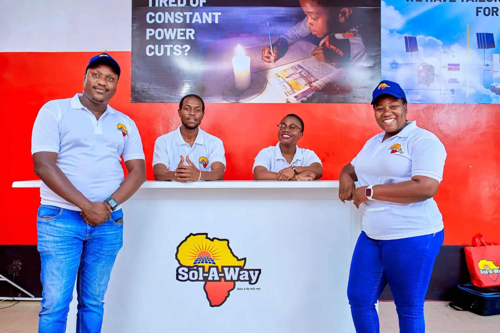 Four Sol-A-Way staff at the branded reception desk in the showroom
